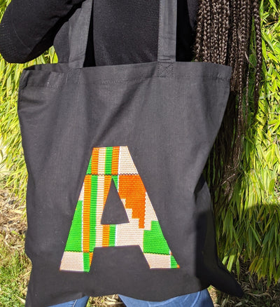 Black tote bag with kente letter detail